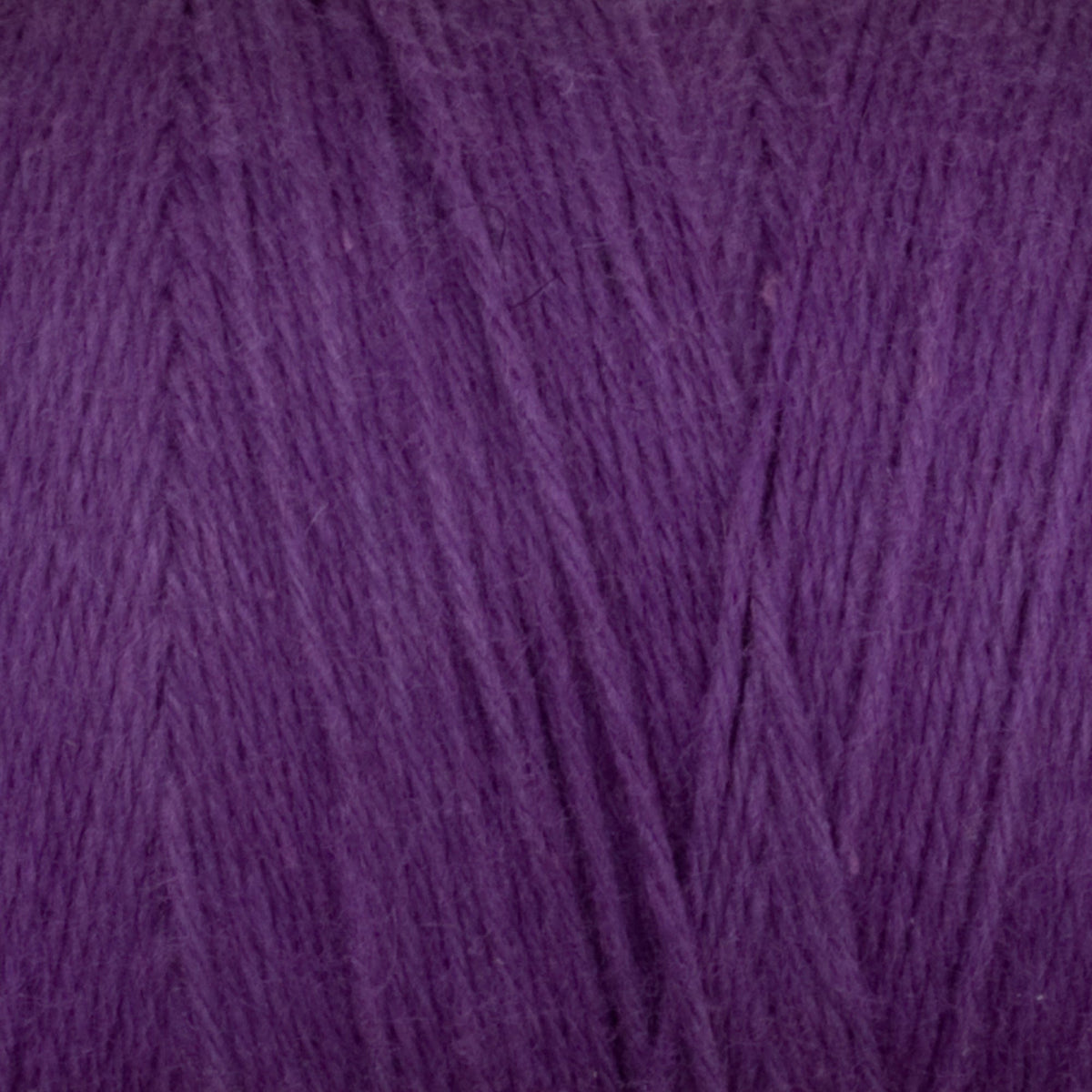 Close-up of Great Northern Weaving Cotton Carpet Warp 8/4 in purple, highlighting the soft texture and fine, intertwined cotton fibers.