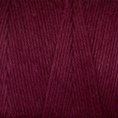 Close-up of Great Northern Weaving Cotton Carpet Warp 8/4 in deep burgundy, showing the colorfast cotton yarn’s detailed texture and tightly twisted fibers.