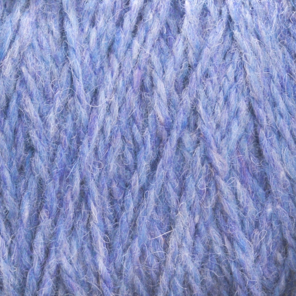 Close-up view of soft blue and purple multicolored Harrisville Shetland Yarn - Unwashed Cones by Harrisville Designs, showing woven strands with fine texture and delicate fibers—ideal for Fair Isle knitting or crafting lightweight blankets.