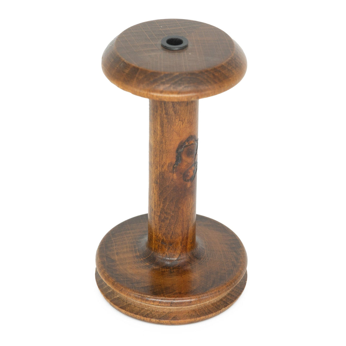The Louët Standard Bobbin by Louet Inc. is a wooden spool with a cylindrical shape and circular base, showcasing a polished surface and natural wood grain. A small hole is centered on the top.
