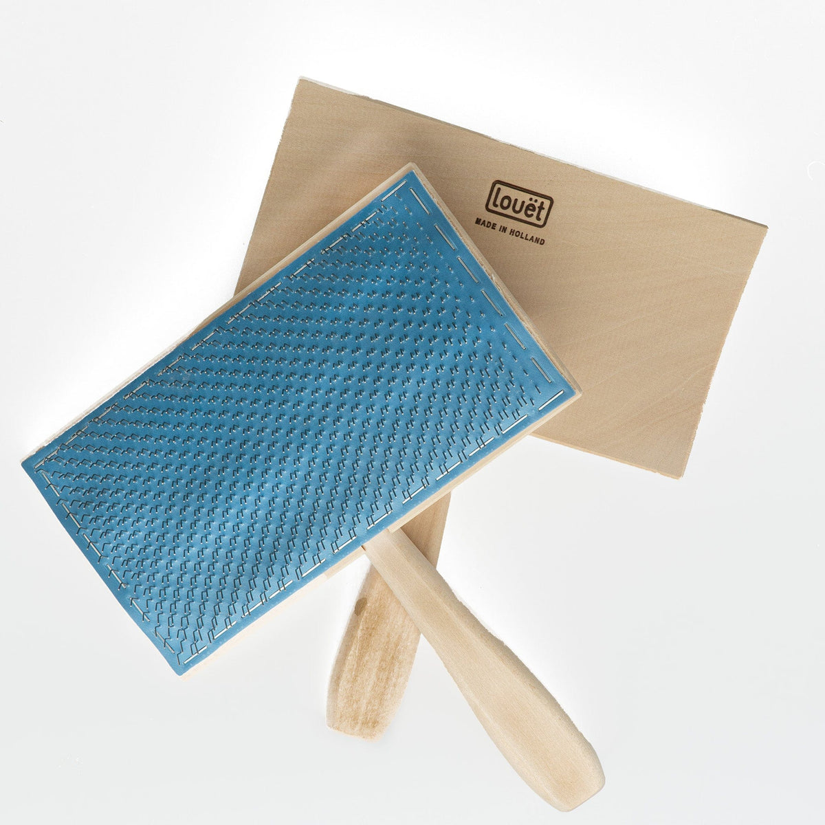 Two Louët Wool Carders by Louet Inc. are shown, one showcasing its blue pin-covered surface and the other displaying its wooden back. The tools have natural wooden handles and are perfect for spinners preparing finer fleeces.