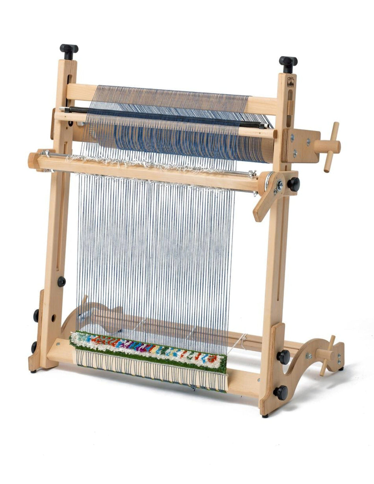 The Schacht Spindle Co. Arras 20" Tapestry Loom Beam Kit is a wooden loom with adjustable knobs and side Beam Kit, set up with vertical threads and partially woven with colorful yarn—temporarily out of stock w/Schacht.