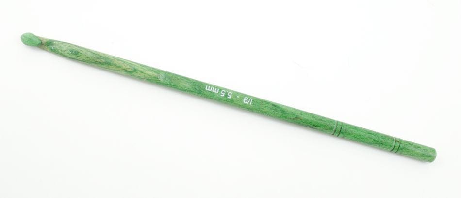 A Knit Pro (Knitters Pride) Dreamz Wooden Crochet Hook by Accessories Unlimited, green in color, with "J/9 - 5.5 mm" printed in white on the side, is placed diagonally on a white background.