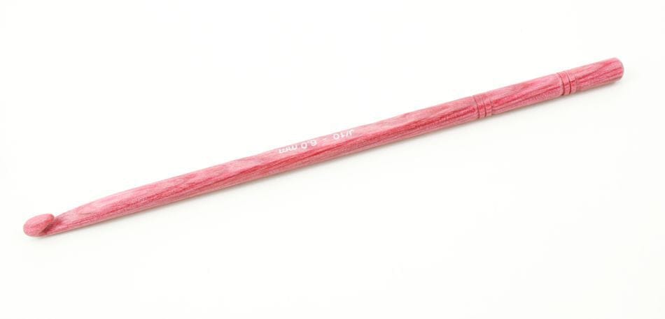 The Accessories Unlimited Knit Pro (Knitters Pride) Dreamz Wooden Crochet Hook, featuring a pink finish and smooth, rounded tip, is placed diagonally on a white background.