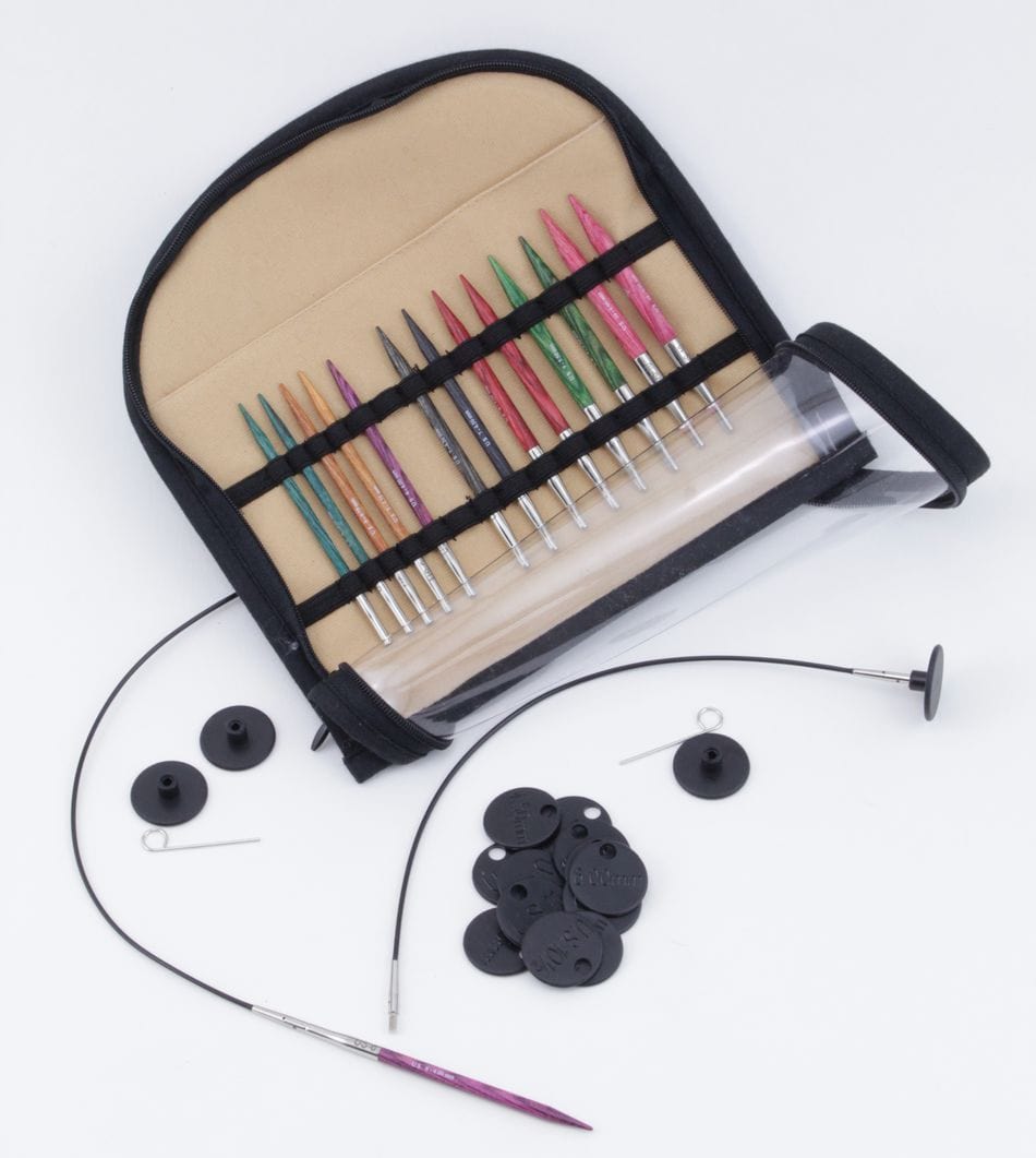 The Accessories Unlimited Knit Pro (Knitters Pride) Dreamz Interchangeable Circular Knitting Needle Set includes chunky knitting needles, black end caps, tightening keys, cable connectors, and a circular cable in a fabric case displayed on a white surface.