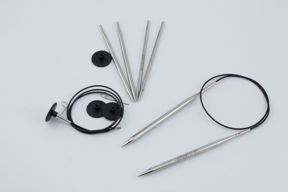 Chrome-plated needle tips, black cables, and circular end caps from the Accessories Unlimited Knit Pro Nova Metal Interchangeable Circular Knitting Needle Sets are arranged on a white background.