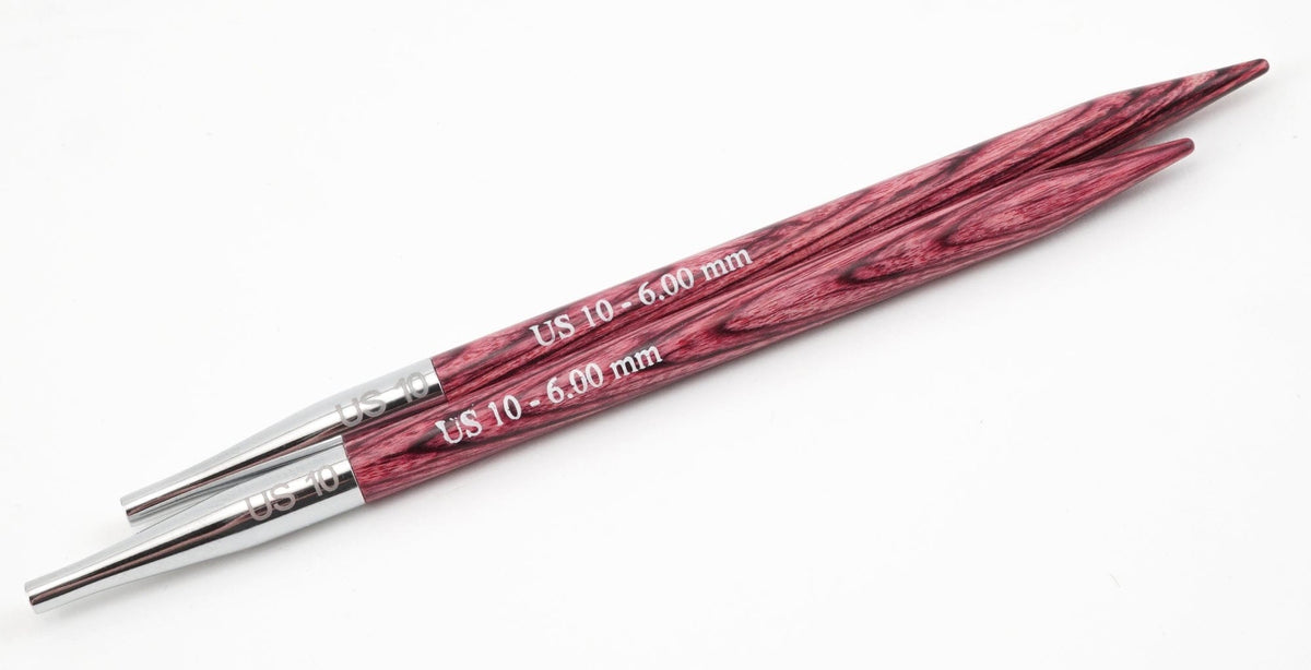 A pair of Accessories Unlimited Knit Pro Dreamz Interchangeable Knitting Needle Tips in size US 10 (6.00 mm), featuring a purple wood grain and silver metal bases, shown side by side on a white background.