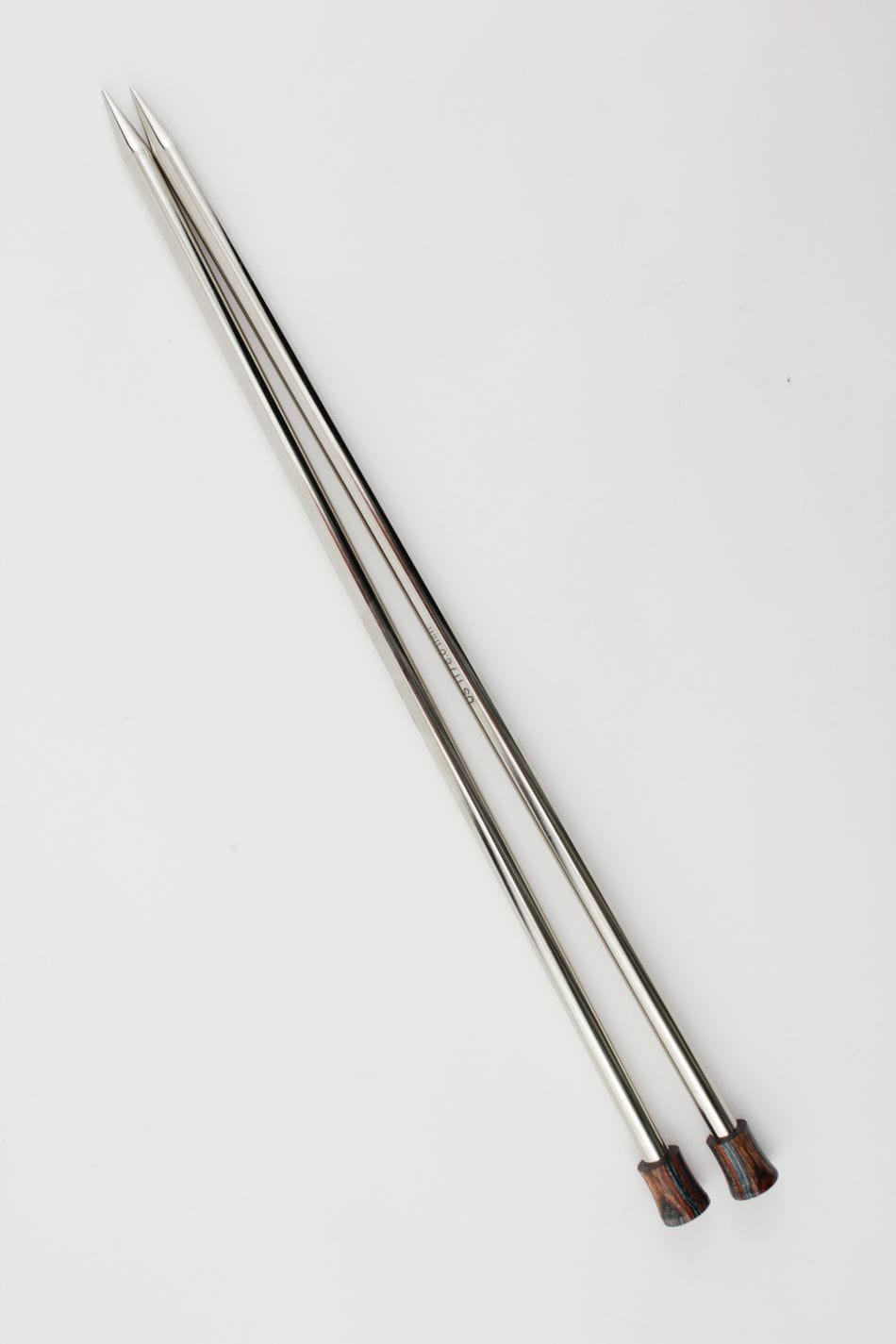 Two Knit Pro (Knitters Pride) Nova Metal Single Point Knitting Needles by Accessories Unlimited, 10" or 14", with pointed tips and dark wooden handles, are placed parallel to each other on a white background.