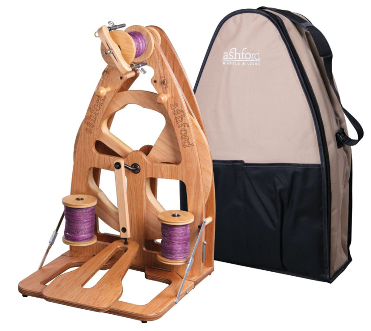 The Ashford Joy 2 Spinning Wheel by Ashford Handicrafts Limited is shown with two purple yarn bobbins and a beige-and-black carry bag. Compact and portable, it's ideal for spinners who love to craft on the go.