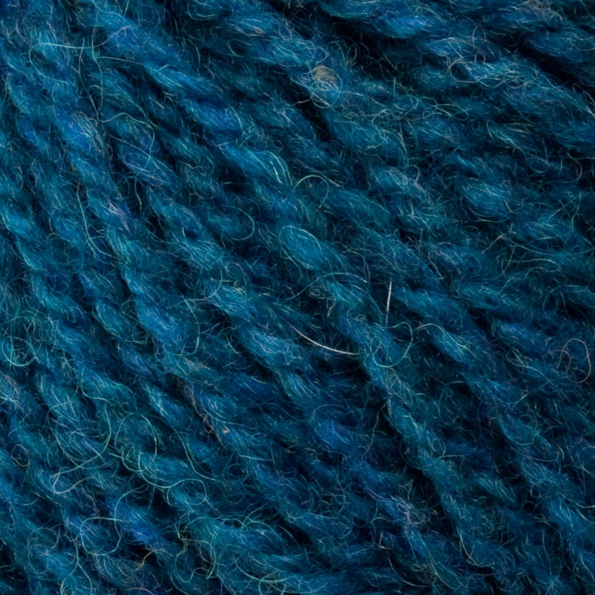 Close-up of Bartlettyarns Maine Wool Yarn (Fisherman 2-Ply), by Bartlettyarns, featuring textured, intertwined blue strands with subtle fuzziness and natural beauty from genuine Maine wool.