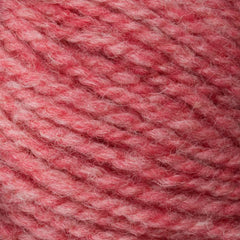 A close-up of Bartlettyarns' Bartlett Maine Wool, Sport Weight Cones features soft, thick yarn in a variegated pattern of light to medium pink. The yarn appears fuzzy and cozy, displaying a homespun texture suggesting it is made of wool.