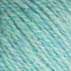 A close-up of Bartlett Maine Wool, Sport Weight Cones by Bartlettyarns reveals turquoise and light blue yarn fibers tightly wound for a textured, homespun look. The intertwined strands create a speckled effect with mixed colors throughout.