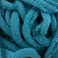 A close-up of the Harrisville Potholder Loops from Friendly Loom reveals intricately interlocking patterns in a tightly woven, textured teal fabric. Crafted from cotton loops, the material boasts soft and thick fibers reminiscent of traditional loom designs, evoking warmth and coziness.