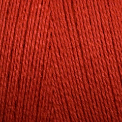 Close-up of Maurice Brassard 8/2 Tencel Yarn | Mini-cone in red, with tightly wound strands showcasing texture and fine fibers—ideal for detailed weaving projects.